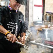 Chef Tong with big smile while cooking lunch at the Baker Creek Spring Planting Festival.