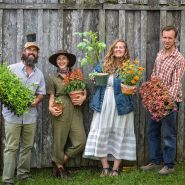 The Baker Creek garden crew smiles while they show off their plants at the Baker Creek Spring Planting Festival.