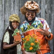 Speakers at the Baker Creek Spring Planting Festival smiling and dressed in vintage 70s attire.