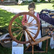 A woman spinning yarn at her vendor booth at the Baker Creek Spring Planting Festival.