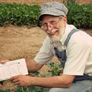 Clyde showing off his amazing Clyde's Garden Planner in the Baker Creek gardens.
