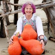 Petaluma Seed Bank manager poses with some Boston Marrow Winter Squash at the beach.