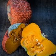 Essex Hybrid Squash, whole and halved on dark background.