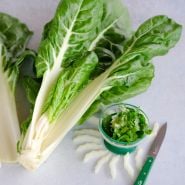 Barese Swiss Chard Leaves with a salad and green knife on a light background.