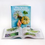 A couple of 2025 Whole Seed Catalogs on a white background with one catalog open.