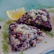 Orangelo Thyme on a plate with 2 black raspberry scones.
