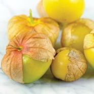 Close-up view of Amarylla Tomatilloes on a white marble countertop.