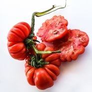Close-up of cut and whole Costoluto Genovese Tomatoes on high key background.