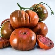A large pile of juicy Paul Robeson Tomatoes on white background.