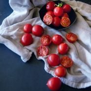 Riesentraube Tomatoes in a bowl and spilling out onto a dishcloth.