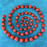 Sweetheart Cherry Tomatoes arranged in spiral on blue background.