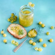 White Currant Tomato with tomato jam on bread on light blue background.