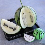 A cut Silver Yamato Watermelon on a Japanese tray with watermelon shaped salt and pepper shakers.
