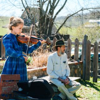 A young violinist plays her instrument at the Baker Creek Tulip Festival.