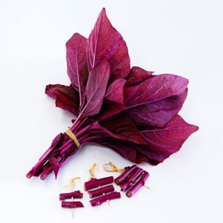 A bundle of Beetroot Vlathankara Amaranth with stems on toothpicks on a white background.