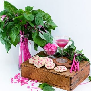 Chopped juiced and cookies made from Pink Beauty Amaranth on a white background.