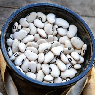 A bowl of Alabama Blackeyed Butterbean Lima Beans in a ceramic bowl.