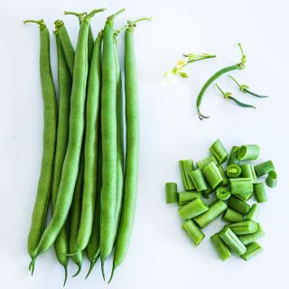Whole and cut Derby Beans arranged on a white background.