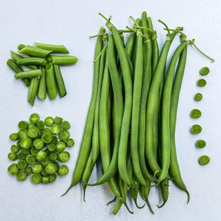 Overhead view of cut and whole Opera Beans arranged on a light background.