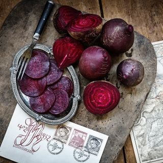 Cut and whole Betina Beets with maps and postcard from The Czech Republic on wood.