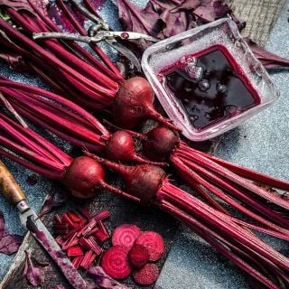 Bull's Blood Beets with a crystal bowl full of juice and garden clippers.