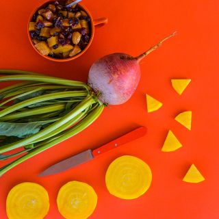 Golden Beets on an orange background with Roasted Beet Salad.