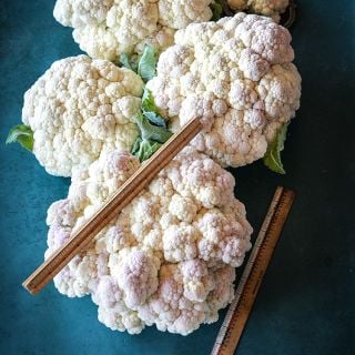 Rober Cauliflower heads with ruler.