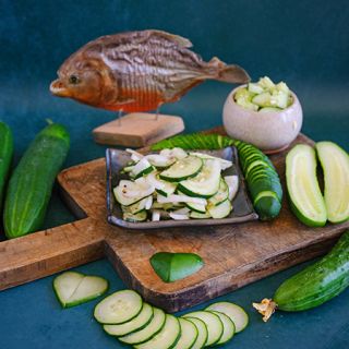 Ancash Market Cucumber and cucumber salad and slices on a blue background.