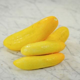 Gele Tros Cucumbers on marble counter top.