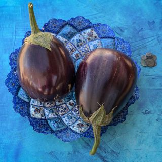 Aswad Eggplant on blue plate and background.