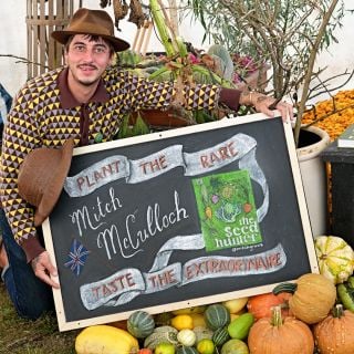Mitch with cool calk sign at the Baker Creek Fall Harvest Festival.