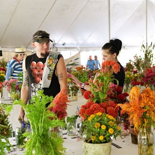 People prusing the displays in the exhibition tent at the Baker Creek Fall Harvest Festival.