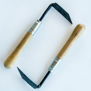 A couple of hand-forged Cape Cod Right and Left Handed Weeders arranged on white background. 