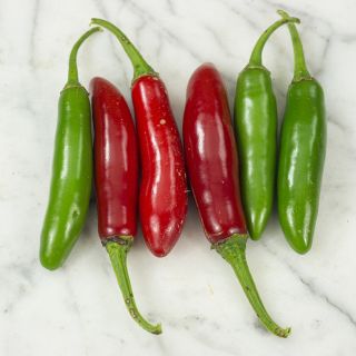 Serrano Tampequino Peppers on marble countertop.