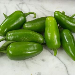 Tam Jalapeno Peppers on marble countertop.