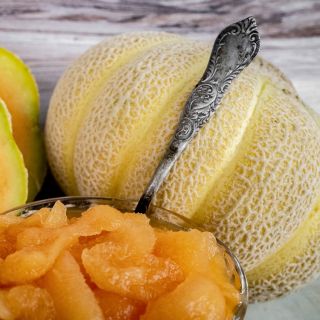 Golden Jenny Melon with close-up of melon meat in cup.