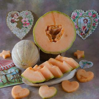 Sweet Passion Melon halved exposing "heart" center.