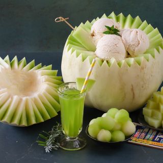 White Lanzhou Melon bowl with ice cream in it on a dark green background.