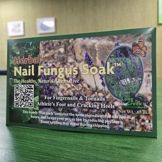 Herbal Nail Fungus Soak in packaging on white background.