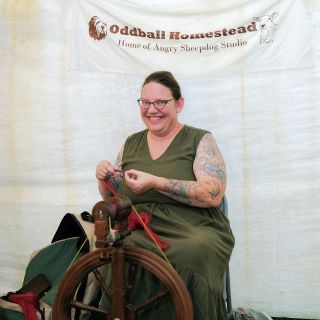 A woman spinning yarn at the Baker Creek Fall Harvest Festival.