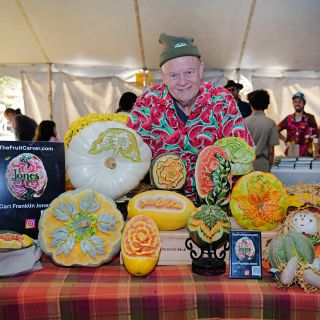 Fruit carver Carl Jones poses with his art at the Baker Creek Fall Harvest Festival.