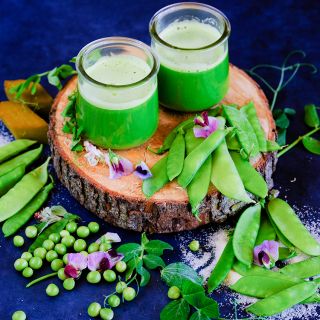 Carouby De Maussane Peas with pea juice on a wooden plank.