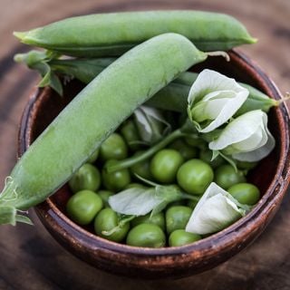 Lillian's Caseload Peas in bowl with blossoms.