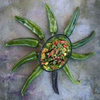 Anaheim Peppers in sun shape on marbled background.