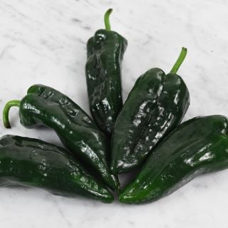 Poblano Pepper spray on marble background.