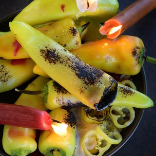 Hungarian Hot Wax Peppers charred under an open flame.