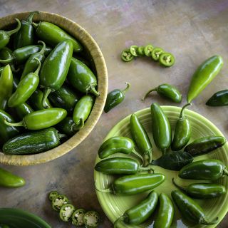 Tam Jalapeno Peppers, on plate and in bowl on neutral background.