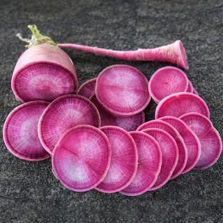 Sliced Pusa Gulabi Radish on a stonebackground.