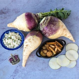 A trio of Marian Rutabagas with cole slaw and fried rutabaga on a light background.