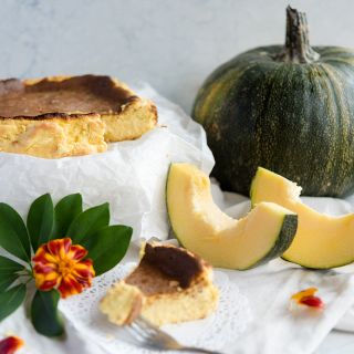 Lady Godiva Winter Squash cheescake recipe with a pumpkin in the background.